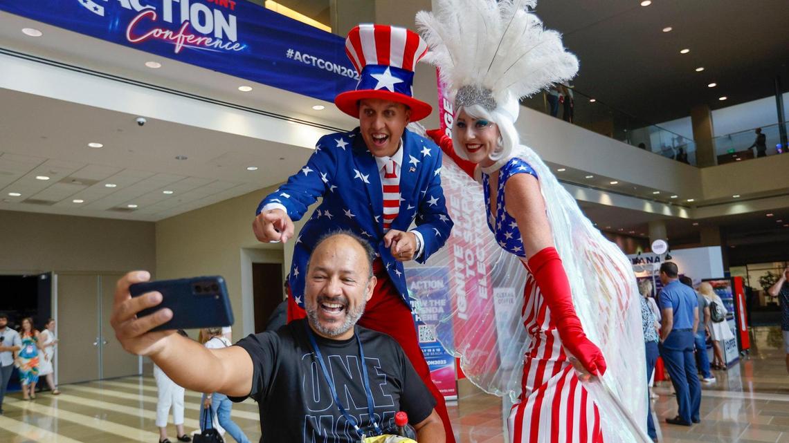 Nick Gall and Kelly Slaton with Palm Beach Stilts pose with Oscar Chacon during the Turning Point Action Conference at the Palm Beach County Convention Center in West Palm Beach, Florida, on Saturday, July 15, 2023.