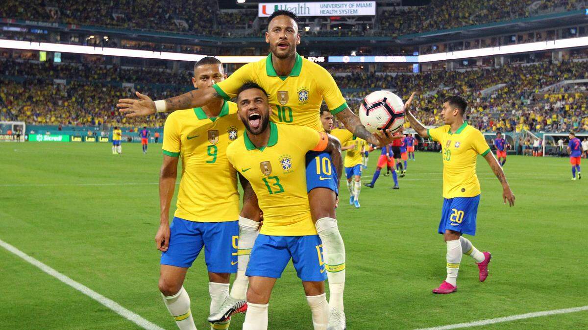 Brazil forward Neymar (10) celebrate with Dani Alves (13) and Richarlison (9) after scoring the second goal of his team during the second half of an international friendly soccer match against Colombia at Hard Rock Stadium on Friday, September 6, 2019, in Miami Gardens.