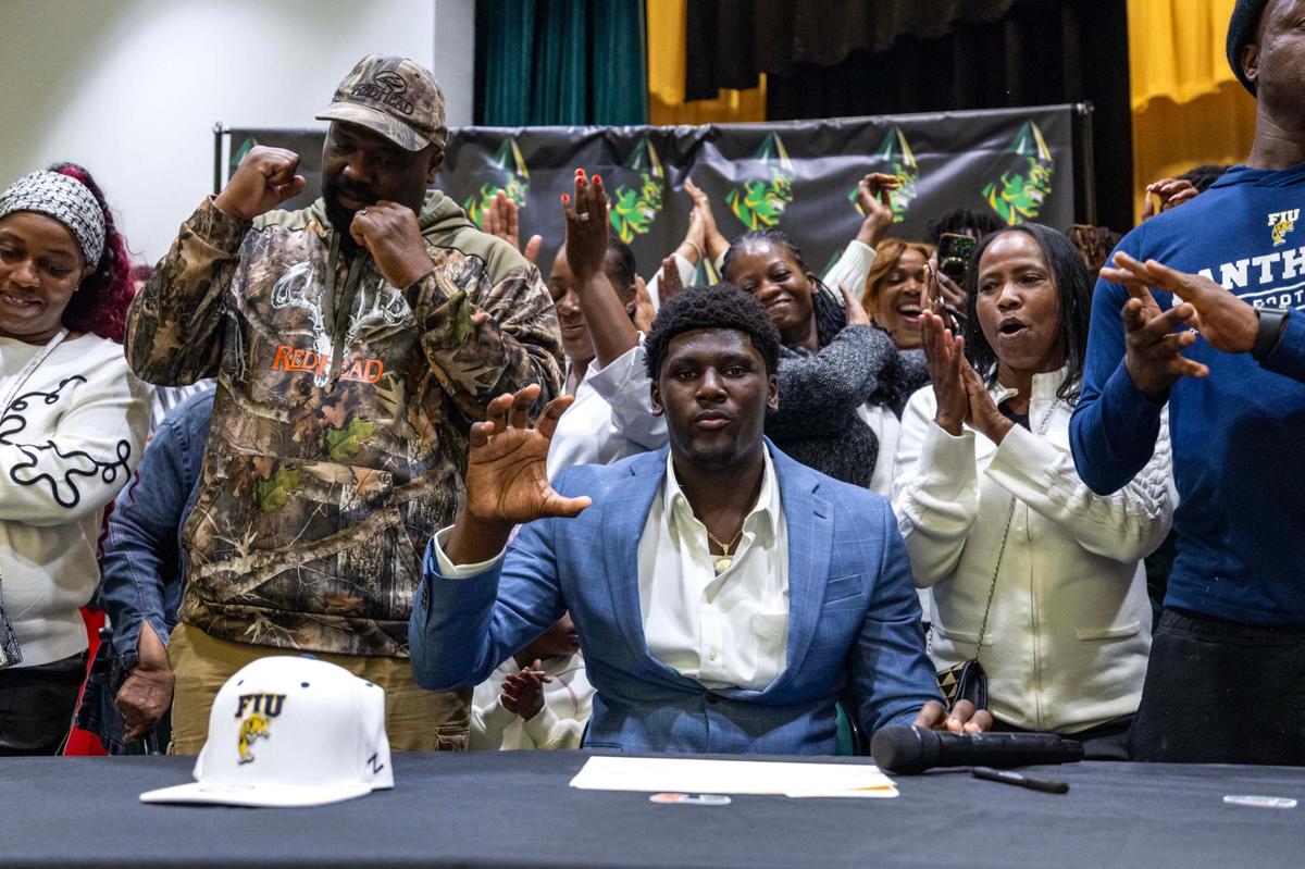 Miami Central’s Jeremy Smith and his family react after he signed with Florida International University during signing day at Miami Central High School on Wednesday, Dec. 4, 2024, in Miami, Fla.