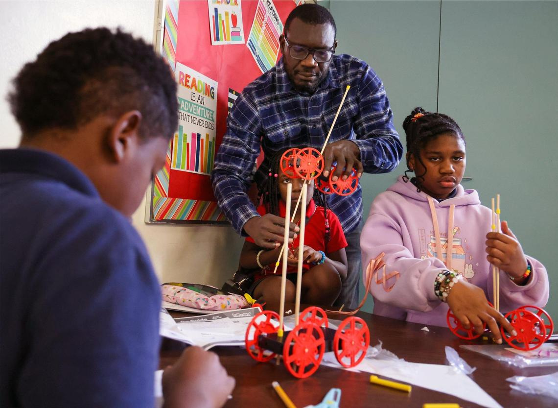 Thechelet Charles, center, helps Leilani Huntley, 8, and Luru Brutus, 10, and Emma Joseph, 8, work on assembling their models during S.T.E.M. class at the after-school program in Miami Shores Elementary .
