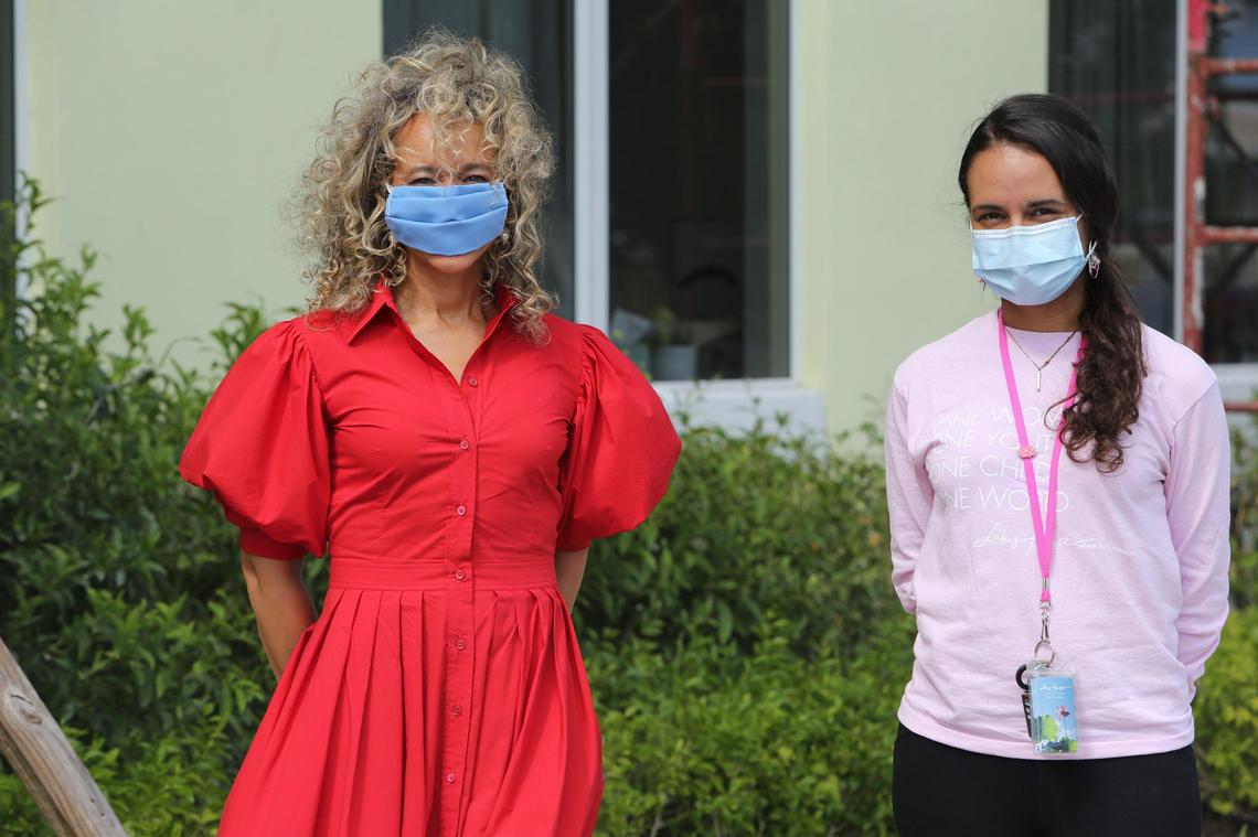 (L) Jacqueline Nickelberry, a New Yorker who splits her time in Miami, and Beatrice A. Gonzalez, community outreach director at Lotus House, stand outside of the residential center on Wednesday April 29, 2020. Nickelberry was on a run recently when she noticed a homeless woman sleeping on a bench. It turned out the woman was eight months pregnant and Nickelberry ended up connecting the woman to Lotus House. Her idea of a baby shower for the woman morphed into a bigger idea of a Shower for Lotus House. She launched it virtually and hundreds have donated.