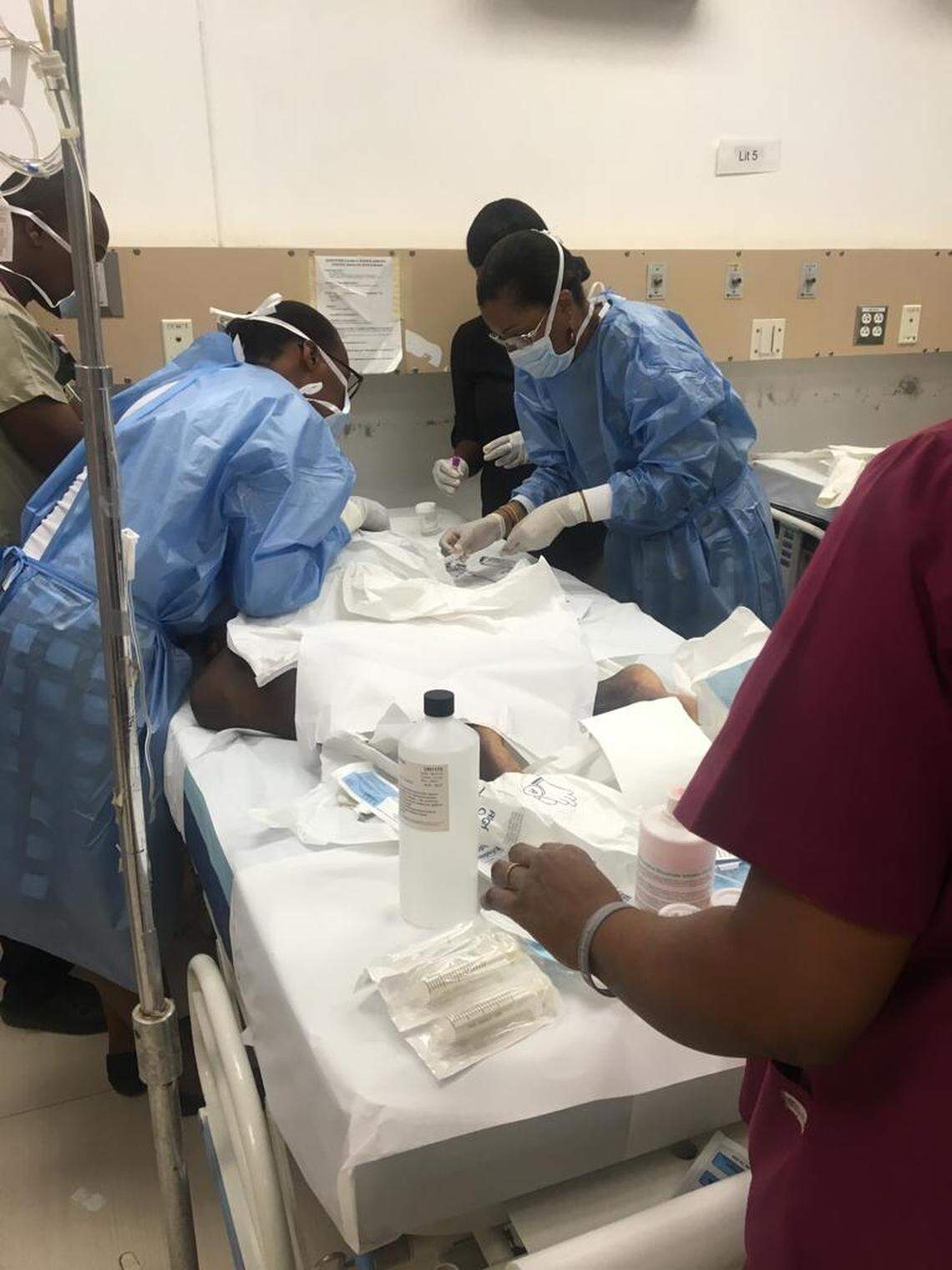 Dr. Pascale Yola Gassant (far right), performs a test on Djooly Jeune, 18, while the staff at the University Hospital of Mirebalais in central Haiti observe. Gassant, a pediatric oncologist, founded Hait’s only childhood cancer program at St. Damien Pediatric Hospital in metropolitan Port-au-Prince.