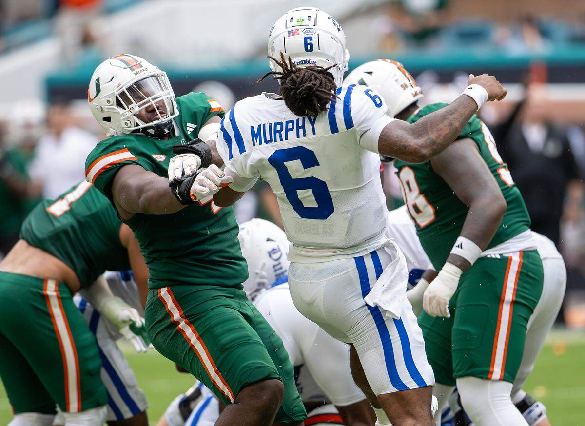 Miami Hurricanes defensive lineman Rueben Bain Jr. (4) pressures Duke Blue Devils quarterback Maalik Murphy (6) during the second half of an ACC football game at Hard Rock Stadium on Saturday, Nov. 2, 2024, in Miami Gardens, Fla.