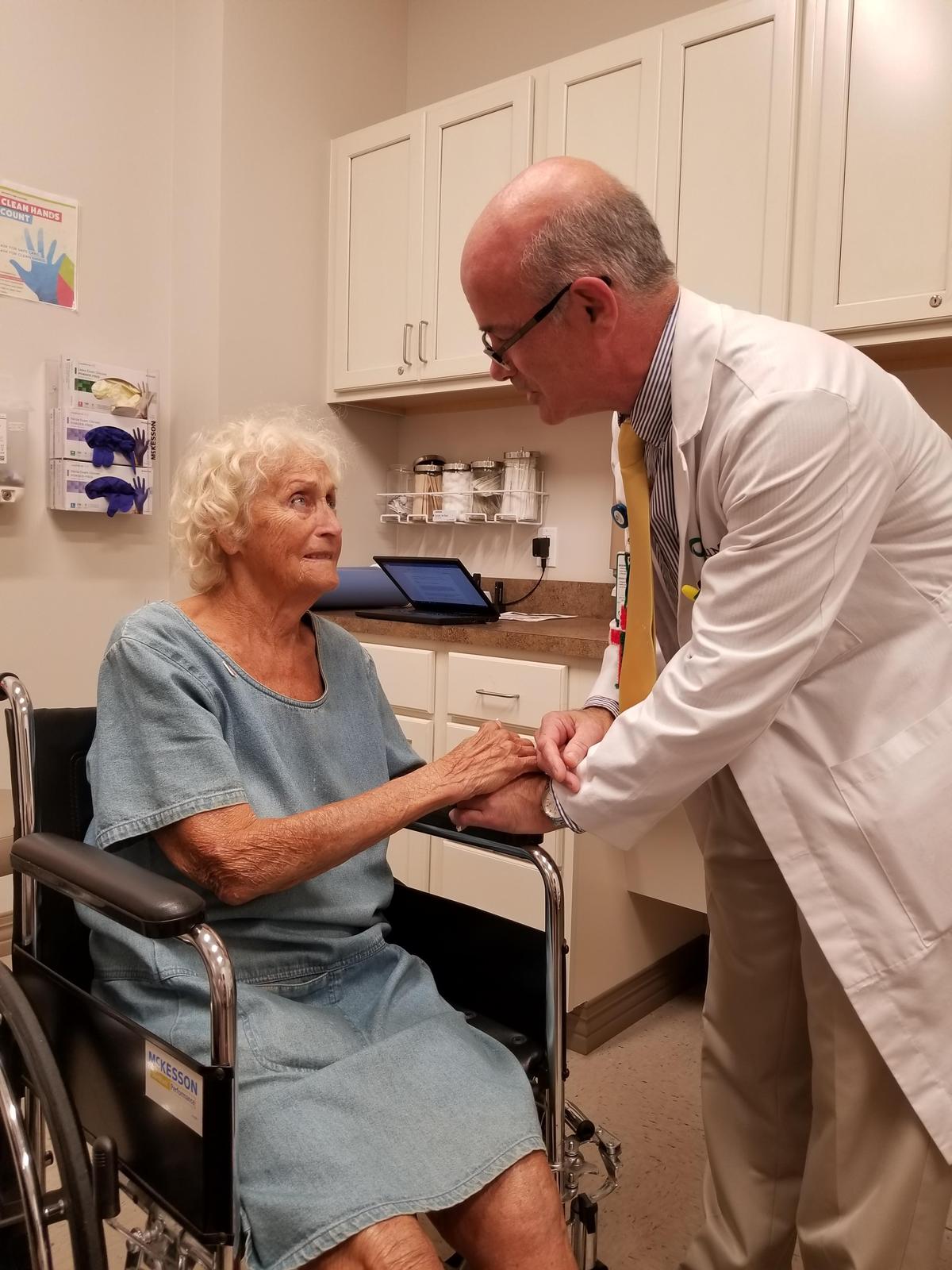 Dr. Christopher Rao, a family doctor at WellMed in Stuart, comforts Priscilla Finamore about seeking inpatient rehabilitation care.