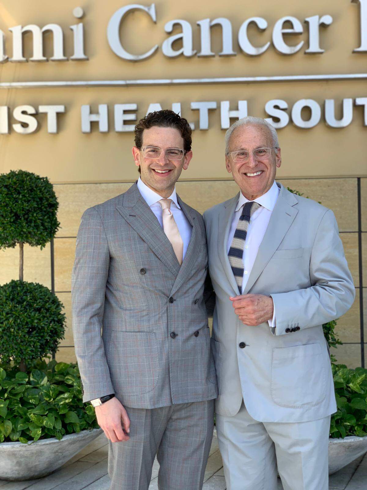 Noah Kalman, left, and Leonard Kalman, right, outside Baptist Health South Florida.