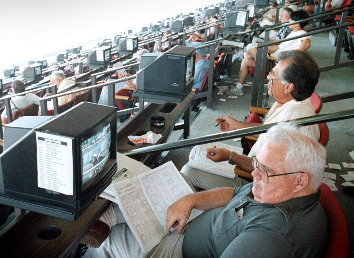 In this file photo from July 24, 1996, Leo Gorman and Steve Alaimo were among the thousand who showed up at Calder Racetrack to bet on horse races. But there were no horses at Calder that day. They were betting on races at other tracks around the country, via simulcast television.