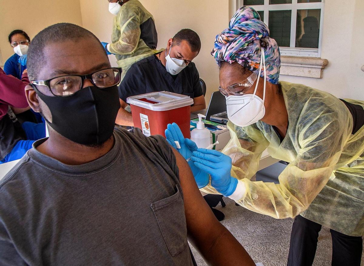 Broward resident Delvis Rogers is vaccinated at a Miami-Dade County mobile vaccination unit administering doses of the Pfizer vaccine from 8 a.m. to 3 p.m. at the South Miami Children’s Clinic on Saturday, March 20, 2021.