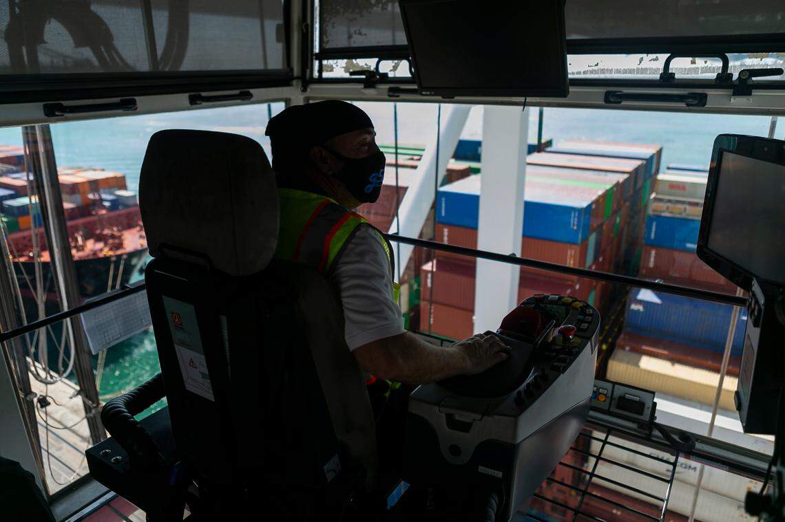 Longshoreman David Marks, a gantry operator, works to offload containers from a docked ship at PortMiami on Saturday, February 20, 2021. Marks has been working as a longshoreman for 19 years.