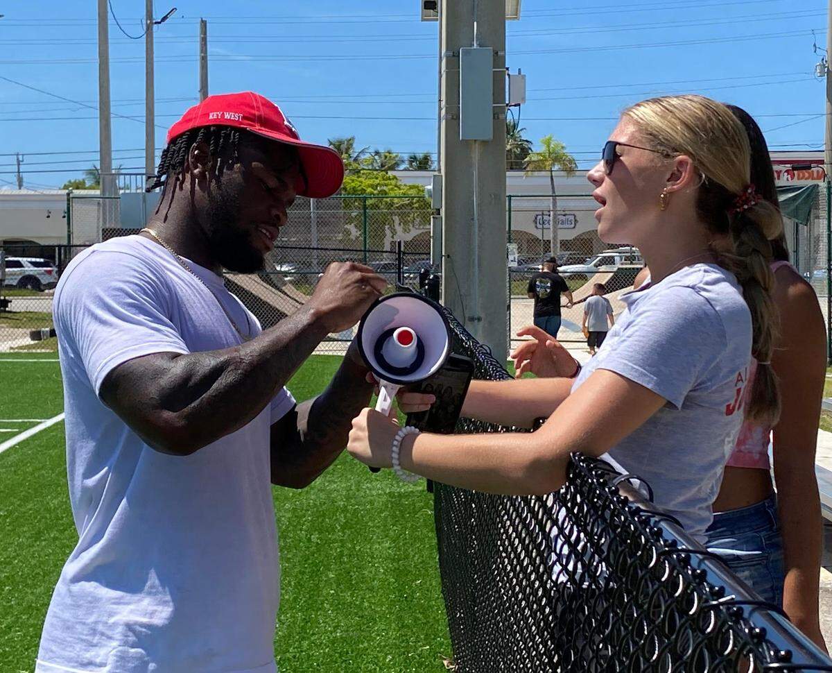 Mekhi Sargent, 24, a running back with the Jacksonville Jaguars, hands out an autograph in Key West on June 24, 2022.