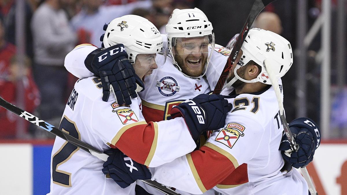 Florida Panthers left wing Jonathan Huberdeau (11) celebrates with defenseman MacKenzie Weegar, left, and center Vincent Trocheck, right, after an NHL hockey game against the Washington Capitals, Friday, Oct. 19, 2018, in Washington. Huberdeau scored the deciding shootout goal. The Panthers won 6-5 in a shootout.