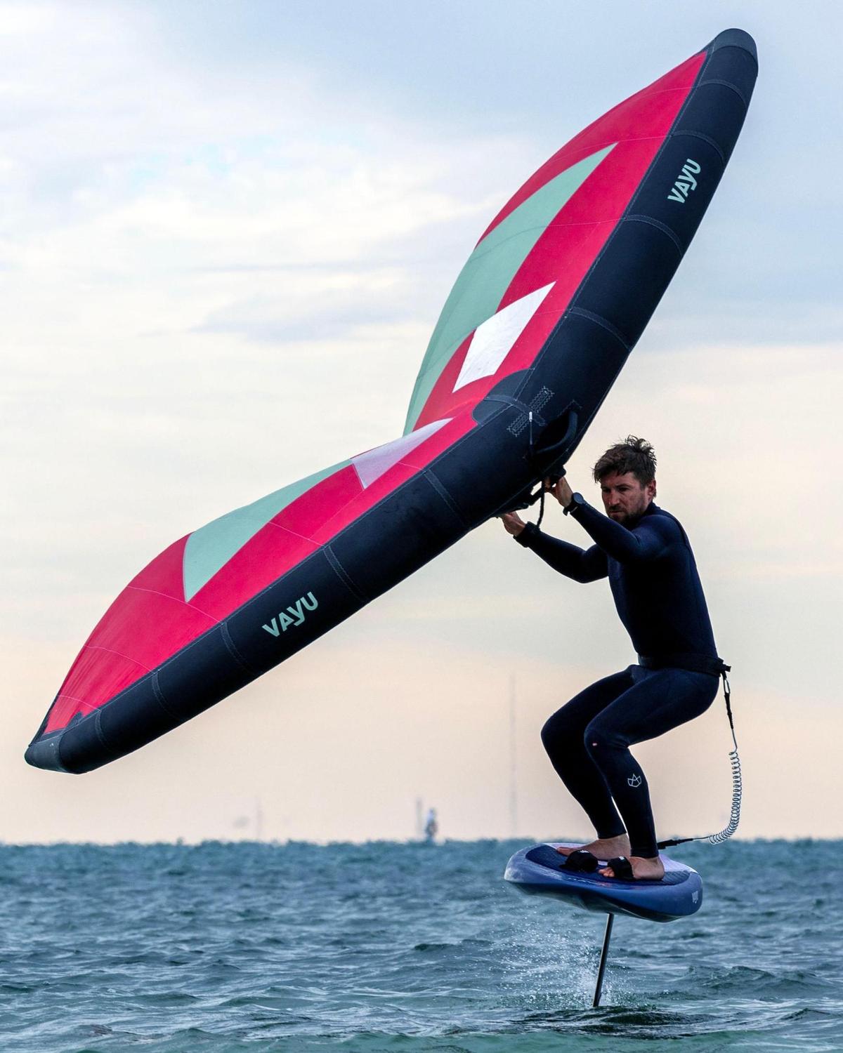 A winger-surfer comes to the shore off Key Biscayne Dog Beach in Miami, Florida, on Saturday, Dec 24, 2022, when temperatures dipped to 48.