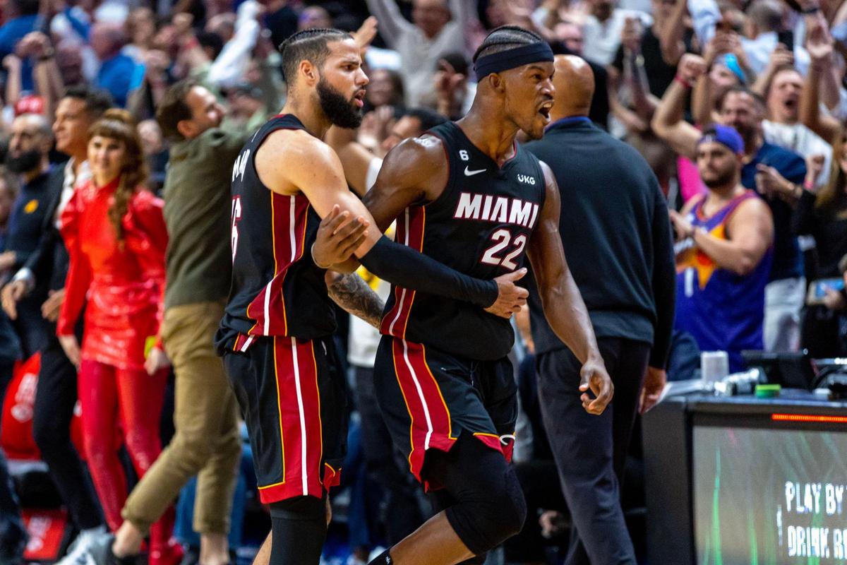 Miami Heat forward Jimmy Butler (22) and teammate Caleb Martin (16) react after defeating the Phoenix Suns 113-112 after the second half of an NBA game at FTX Arena in Downtown Miami, Florida, on Monday, November 14, 2022.