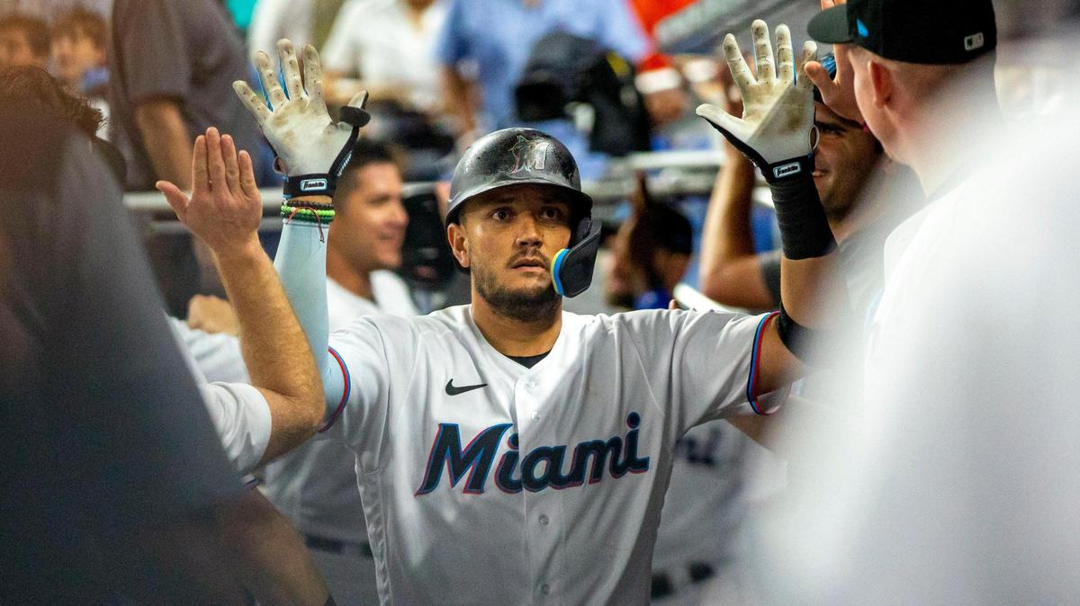 Miami Marlins player Miguel Rojas (11) reacts with teammates in the dugout after he hit a home run on a fly ball to left field during the third inning of an MLB game against the Seattle Mariners at loanDepot park in the Little Havana neighborhood of Miami, Florida, on Friday, April 29, 2022.