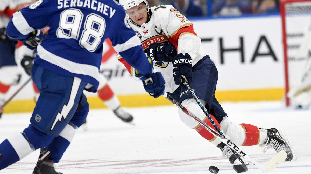 Florida Panthers center Aleksander Barkov (16) handles the puck against the Tampa Bay Lightning defenseman Mikhail Sergachev (98) during the first period of an NHL hockey game Saturday, Oct. 6, 2018, in Tampa, Fla.