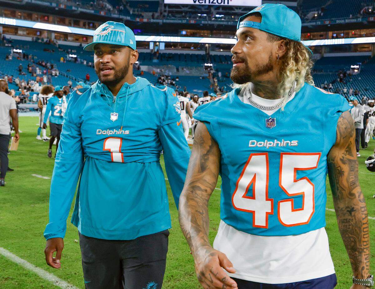 Miami Dolphins quarterback Tua Tagovailoa (1) and Miami Dolphins linebacker Duke Riley (45) walk off the field after the loss against the Atlanta Falcons during a preseason game at Hard Rock Stadium in Miami Gardens on Friday, August 11, 2023.