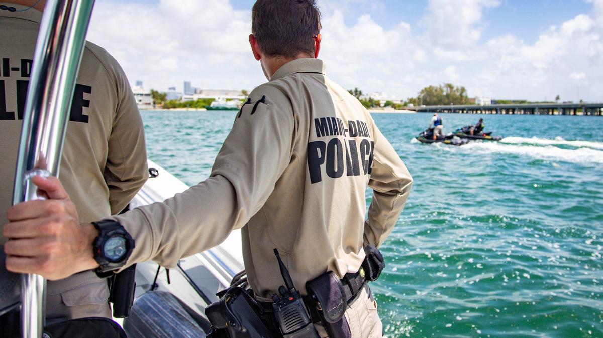 Miami-Dade marine patrol officer Sean Carper looks out at two other officers on jet skis near Crandon Park Marina on Wednesday, July 3, 2024, in Key Biscayne, Florida.