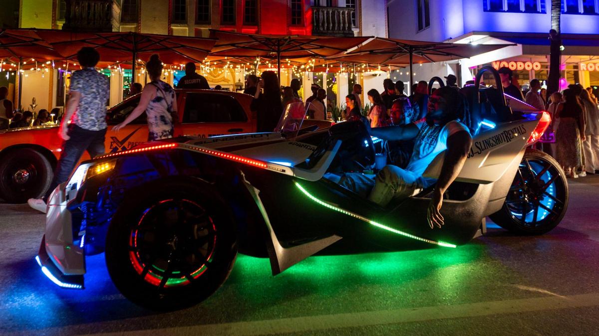 Jacksonville natives CJ and Keke ride around Ocean Drive inside a rented vehicle in Miami Beach, Florida, on Friday, March 3, 2023.