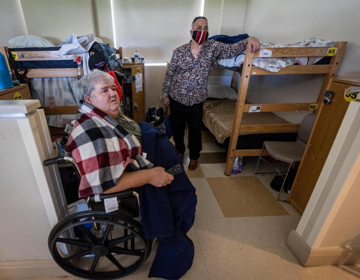 Heriberto Delvalle, right, at his bunk at Camillus House in Miami on Wednesday, July 21, 2021, along with Rolando Guedez, who sleeps in the bunk next to him.