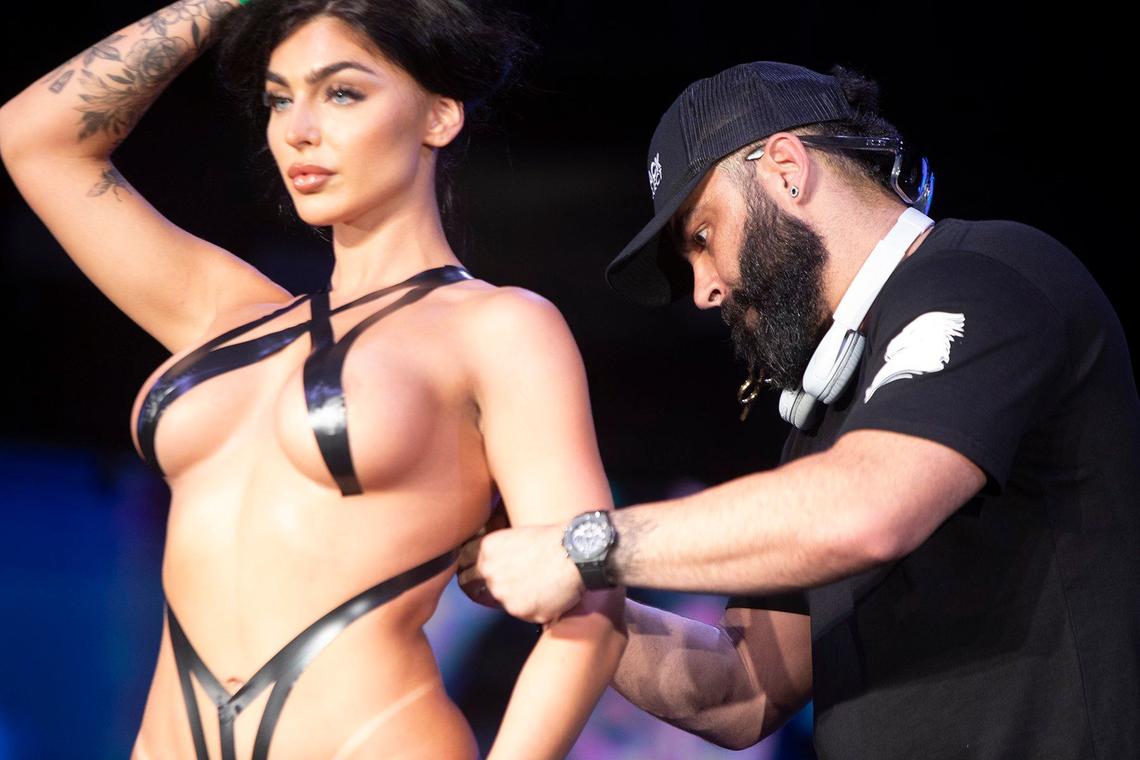The designer , Drakhan Blackhart, the King of Tape, designs swimsuits in tape on model bodies during Miami Swim Week at M2 Club, South Beach on Sunday June 3rd., 2024.