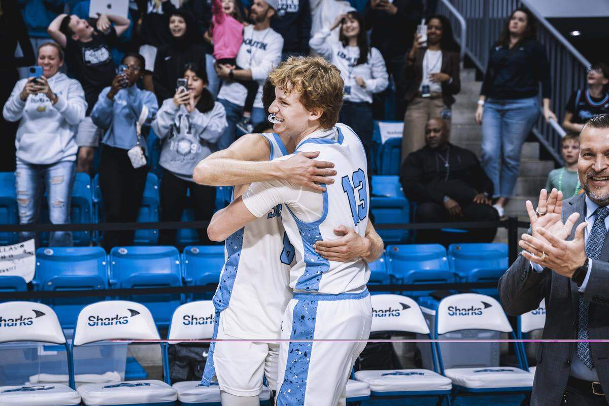 NSU’s Jamie Qualley (13) hugs one of his teammates after the Sharks beat Alabama-Huntsville to advance to the NCAA Division-II Elite Eight.