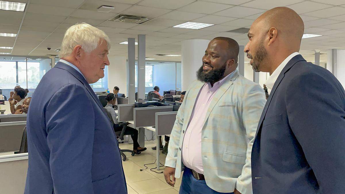 Digicel Group founder and Chairman Denis O’Brien visits his company’s operations in Port-au-Prince, Haiti, on Thursday, Feb. 16, 2023. During a stop at the call center, he stops to chat with Digicel Haiti Chief Executive Officer Jean Philippe Brun, right, and Anderson Destin, head of customer care.