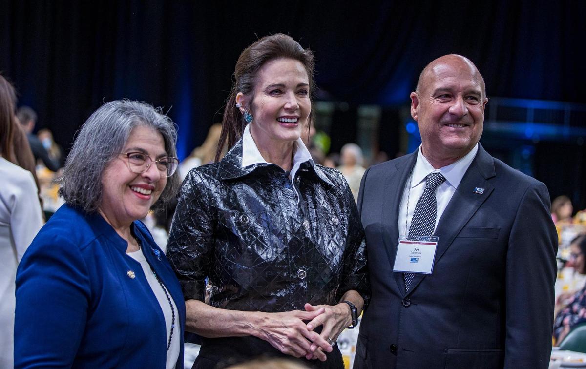 Miami-Dade Mayor Daniella Levine Cava and Joe Zubizarreta stand with former actress and singer Lynda Carter during the 21st annual Women United breakfast event Wednesday at the University of Miami.