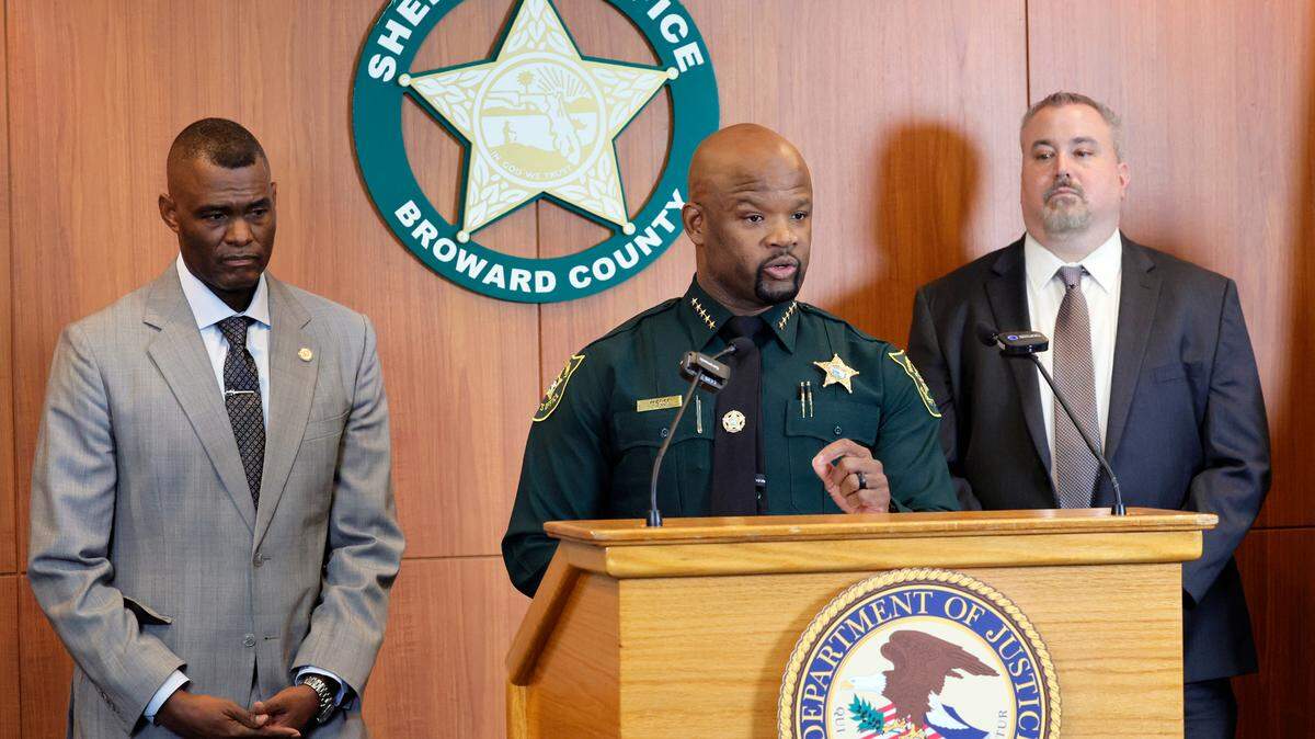 Broward Sheriff Gregory Tony speaks during a news conference at the Broward Sheriff’s Office Public Safety Complex in Fort Lauderdale on Thursday, Oct. 12, 2023. 17 members of BSO have been charged with PPP fraud. Looking on are U.S. Attorney for the Southern District of Florida Markenzy Lapointe, left, and Federal Reserve Board Office of Inspector General Assistant Special Agent in Charge Wayne Rosen.