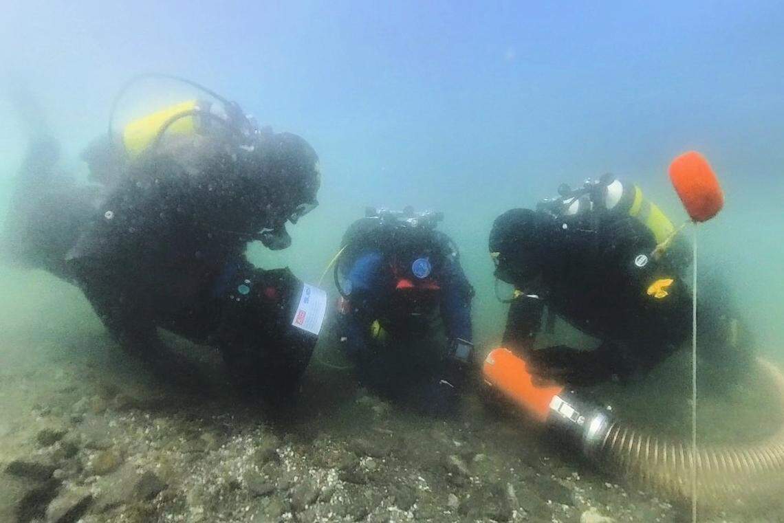 Divers looked below the layers of sediment to find metal artifacts and other pieces.