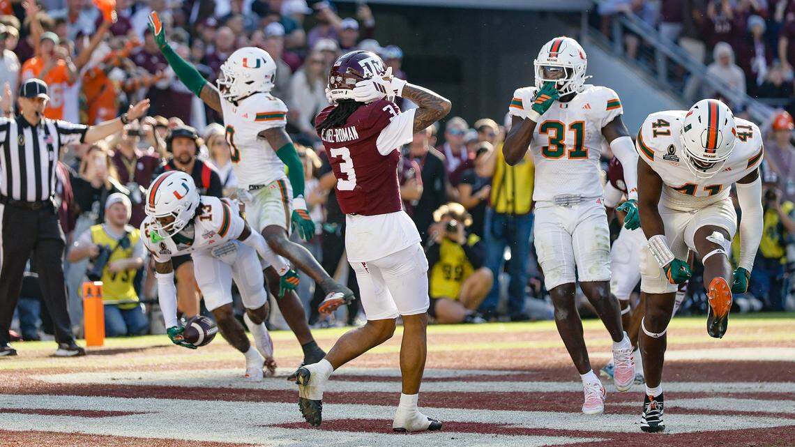 Miami Hurricanes defensive back Bryce Fitzgerald (13) and teammates react after intercepting the ball for a touchback to end the game against the Texas A&M Aggies in the first round of the 2025 College Football Playoff at Kyle Field at College Station, Texas, on Saturday, December 20, 2025.