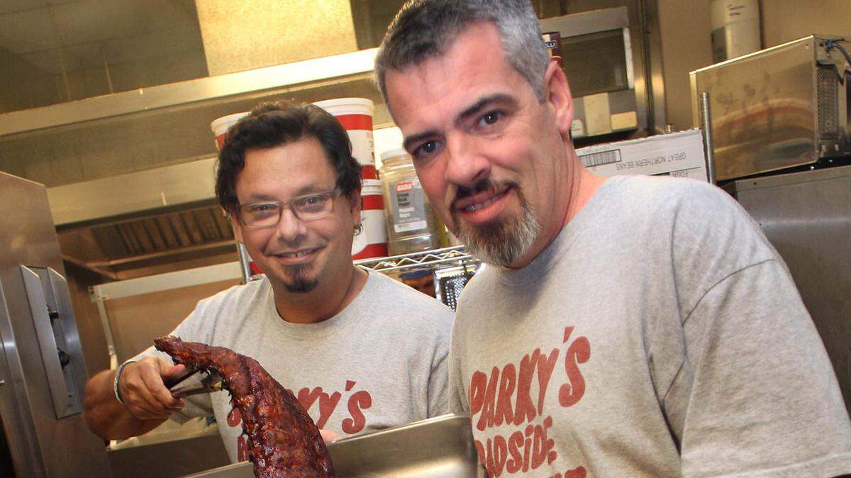 Hans Seitz-(L) and Kevin Kehoe, owners of Sparky’s Roadside Barbeque in downtown Miami show off their Babyback Ribs on Thursday, November 10, 2011.
