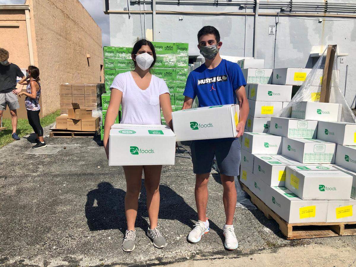 Gabriella Bonwitt and Evan Scheck spend their morning distributing food to families in need with the Jewish Volunteer Center ans the JCS Kosher Food Bank in early June.
