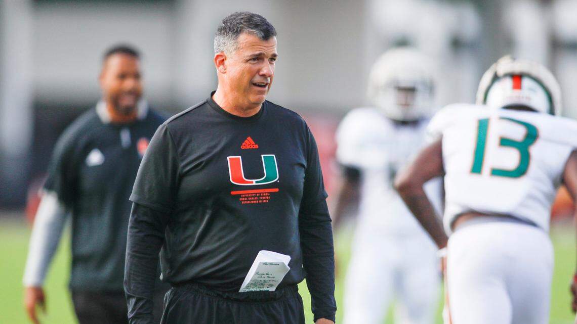 Miami Hurricanes head coach Mario Cristobal watches from the field during football practice at the University of Miami campus in Coral Gables, Florida, Tuesday, August 30, 2022.