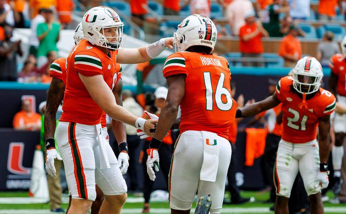 Miami Hurricanes wide receiver Isaiah Horton (16) celebrates with teammate Tyler Van Dyke (9) after scoring a touchdown against Texas A&M during the second quarter of an NCAA non conference game at Hard Rock Stadium on Saturday, Sept. 9, 2023 in Miami Gardens, Florida.