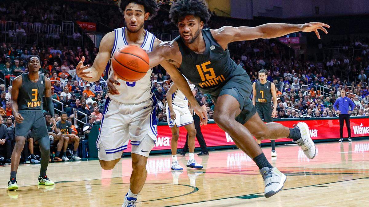 Miami Hurricanes forward Norchad Omier (15) and Duke Blue Devils guard Jared McCain (0) chase a loose ball in the second half at the Watsco Center In Coral Gables, Florida on Wednesday, February 21, 2024.