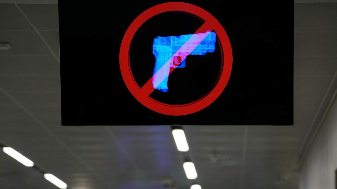 In this file photo, a television displays a “no guns” sign at the Transportation Security Administration security area at the Hartsfield-Jackson Atlanta International Airport on Wednesday, Jan. 25, 2023, in Atlanta.