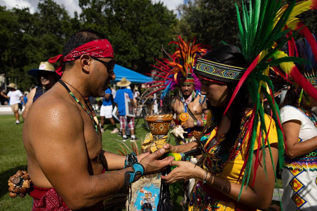 Jennifer Ayala, right, uses the coapl, an incense-like substance, to bless the hands of Alberto Reyes during an Anti-Hate March led by We the People on Sunday, July 2, 2023, in downtown Fort Lauderdale. Coapl what this indigenous group, Tonalxochitl, uses to protect themselves and send prayers to universe.