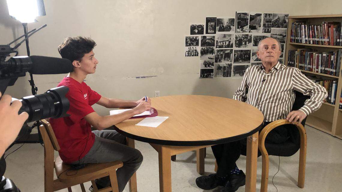 Jonathan Tamen, a ninth-grader at Miami Beach Senior High School, interviews Allan Hall, a Miami Beach resident who was hidden as child during the Holocaust. A group of 20 students interviewed and filmed four local Holocaust survivors to create a documentary that will be shown at the school April 22.