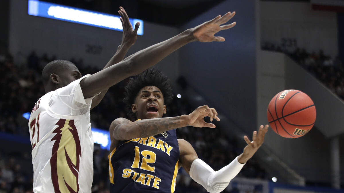 Murray State’s Ja Morant (12) passes the ball under defensive pressure from Florida State’s Christ Koumadje (21) during the first half of a second round men’s college basketball game in the NCAA Tournament, Saturday, March 23, 2019, in Hartford, Conn.