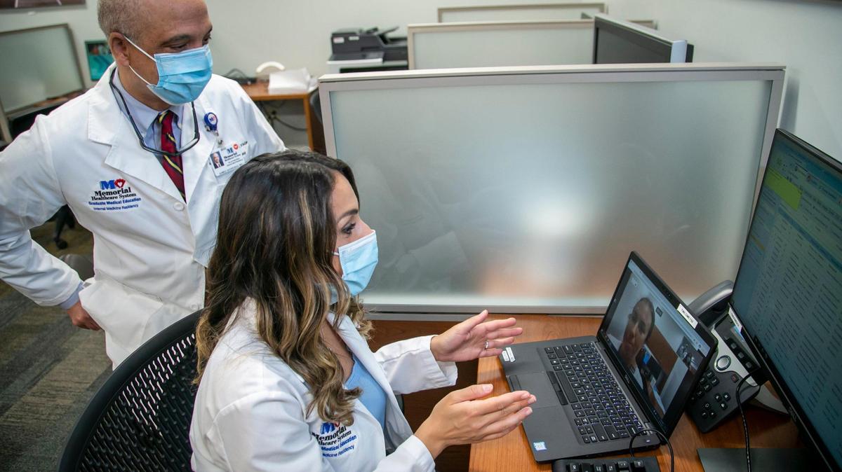 Dr. Ahmed Shoreibah, left, and Dr. Alexandra Cugliari conduct a telemedicine call at Memorial Hospital in Pembroke Pines on Tuesday, April 13, 2021. Cugliari is a resident at Memorial. During the pandemic, she provided telemedicine visits to high-risk patients who had tested positive for COVID. One of the patients was a woman in her 60s who was clearly getting worse at home. She persuaded the patient to let her call 911. She was admitted with COVID pneumonia and eventually was discharged from the hospital.