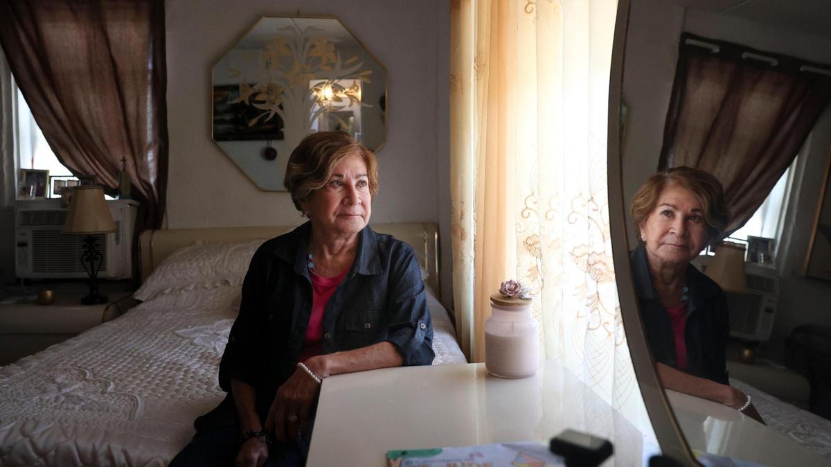 Carmen Gonzalez sits in her bedroom at Shep Davis Apartments in Miami Beach on Sept. 15, 2022. Gonzalez, who receives Section 8 housing assistance, was told to move out amid a dispute between her landlord and the Miami Beach Housing Authority.