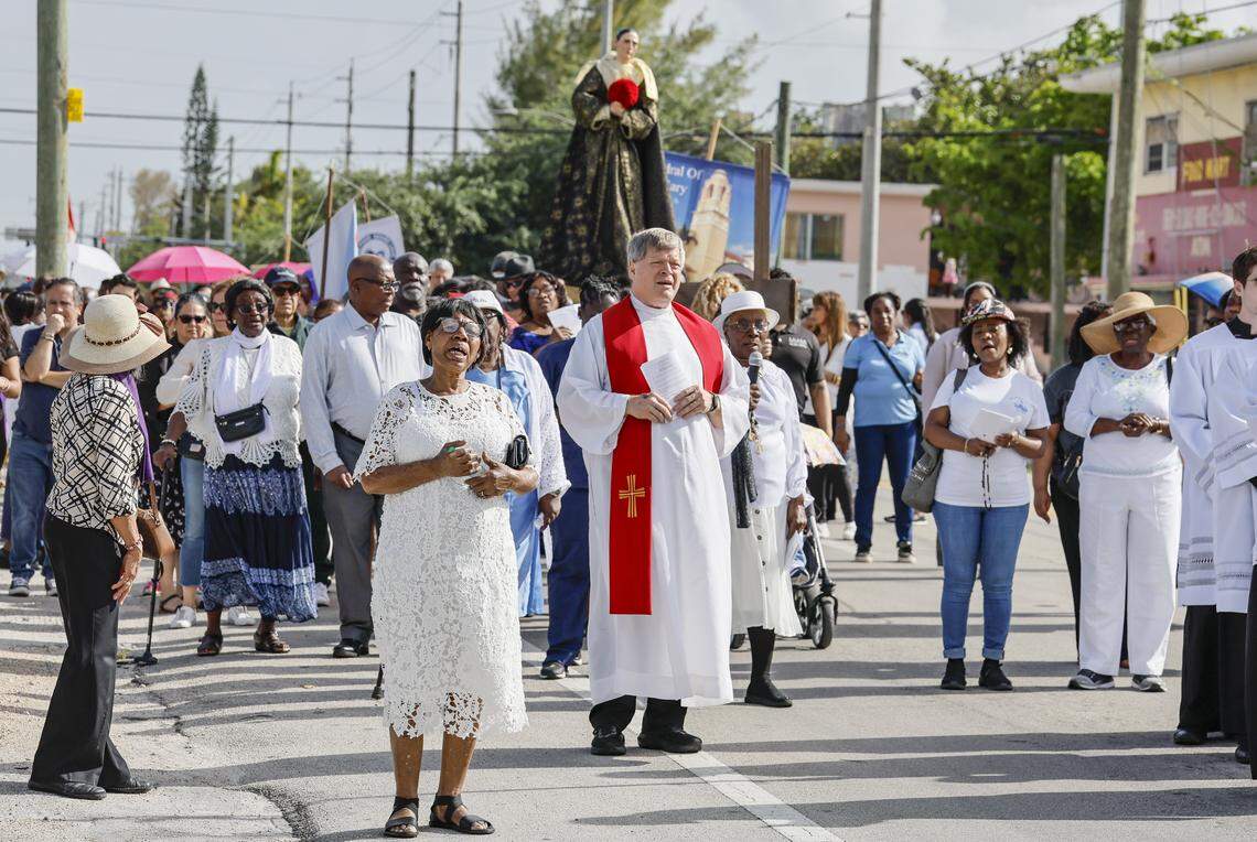 The Rev. Steven O’Hala joins parishioners during the Stations of the Cross procession along Northwest Second Avenue near St. Mary Cathedral on Friday, April 3, 2026, in Miami.
