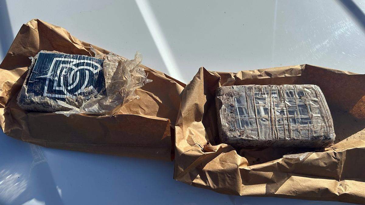 Two bricks of cocaine are displayed on the hood of a Monroe County Sheriff’s Office patrol car Monday, Dec. 16, 2024. The sheriff’s office said they were found washed up on shore in Grassy Key in the Middle Florida Keys.