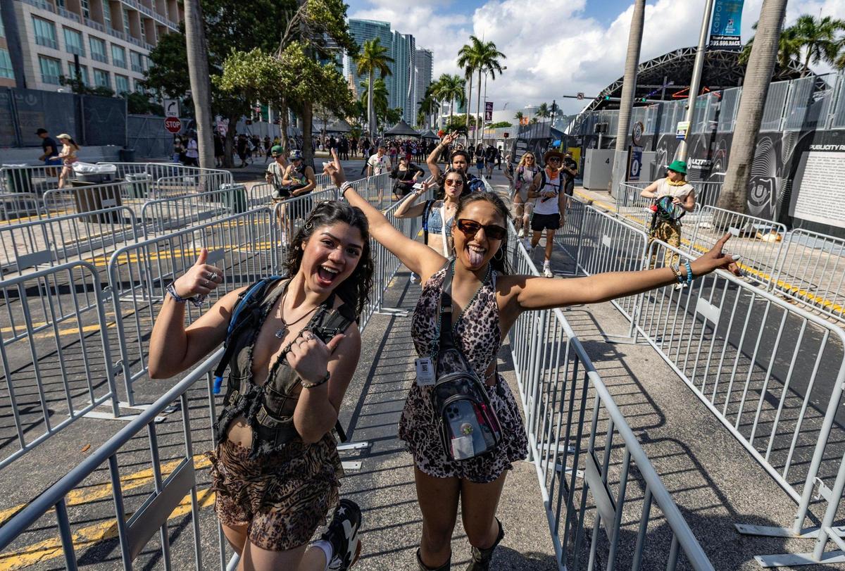 Attendees rush into a security check point as the gates open for Ultra Music Festival’s 25th anniversary at Bayfront Park, in Miami, Florida, on Friday, March 28, 2025.