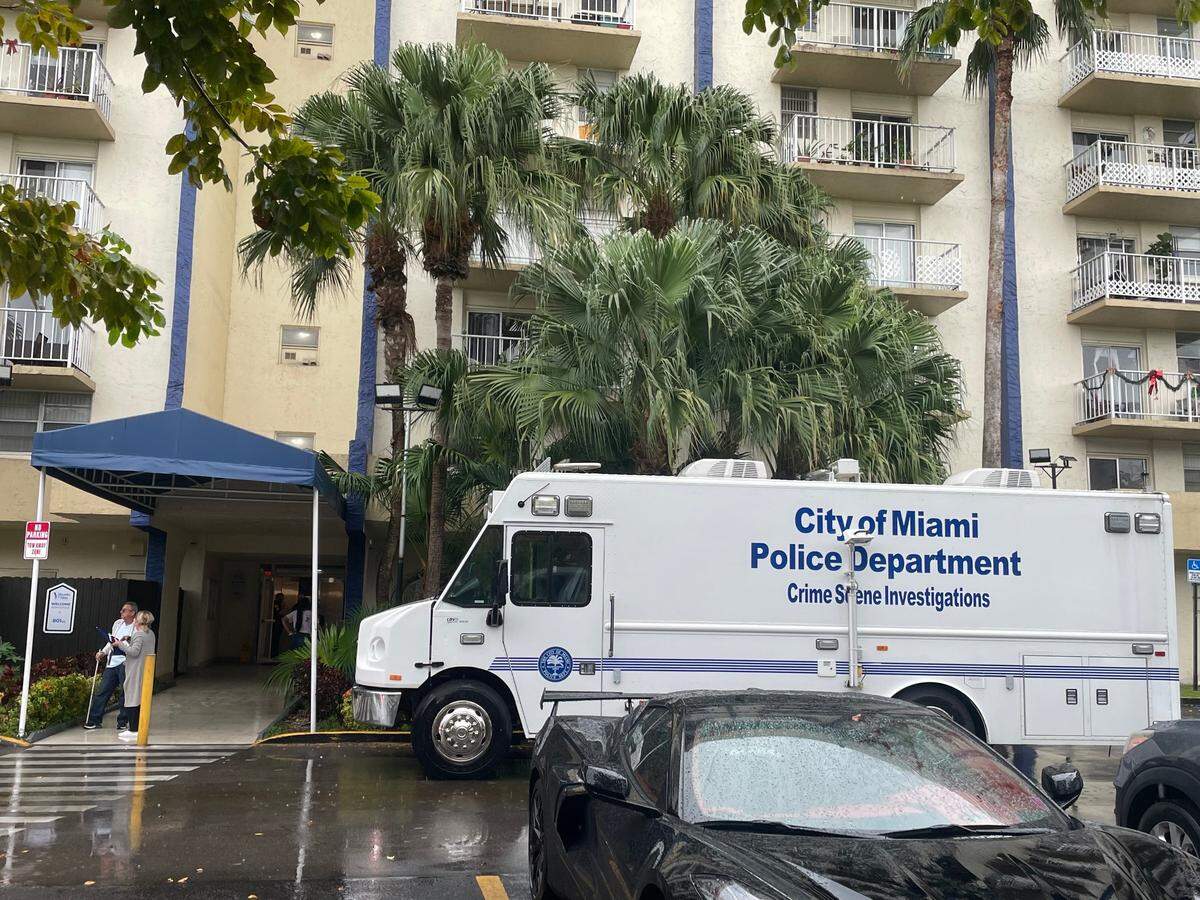 A Miami police crime scene investigations truck is parked in front of the Flagami gated condo building where two women were shot on Wednesday, Dec. 13, 2023.