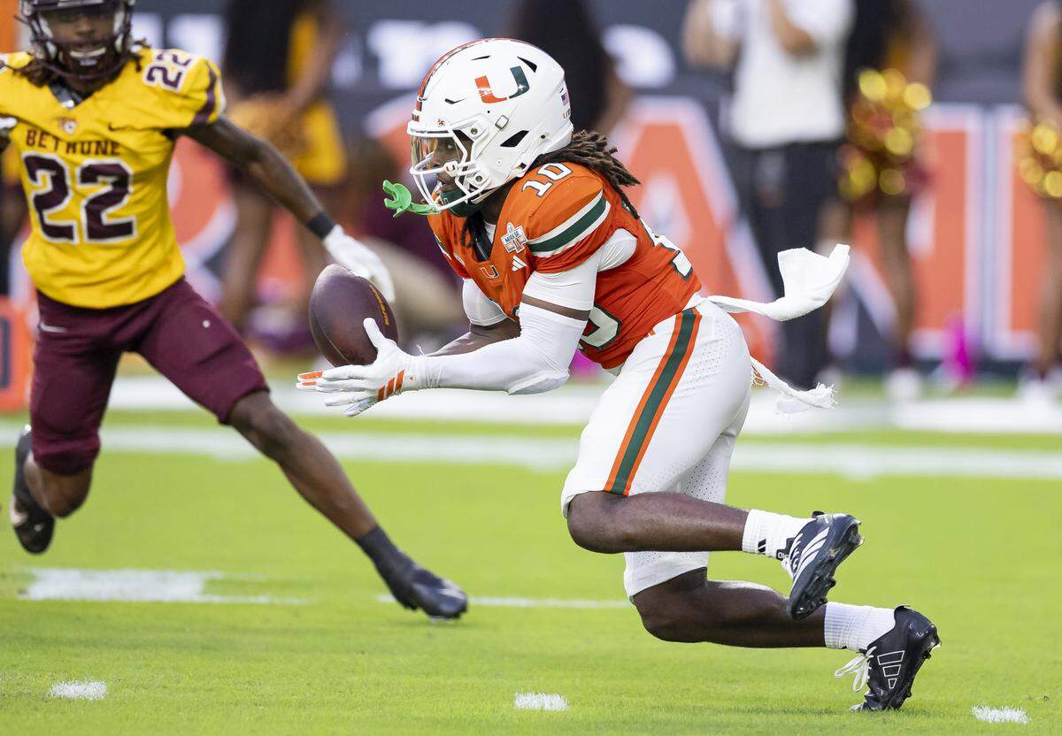 Miami Hurricanes wide receiver Malachi Toney (10) catches the ball on a punt return as Bethune-Cookman Wildcats wide receiver Marquis McCants (22) defends in the first half of their NCAA football game at Hard Rock Stadium on Saturday, Sept. 6, 2025, in Miami Gardens, Fla.