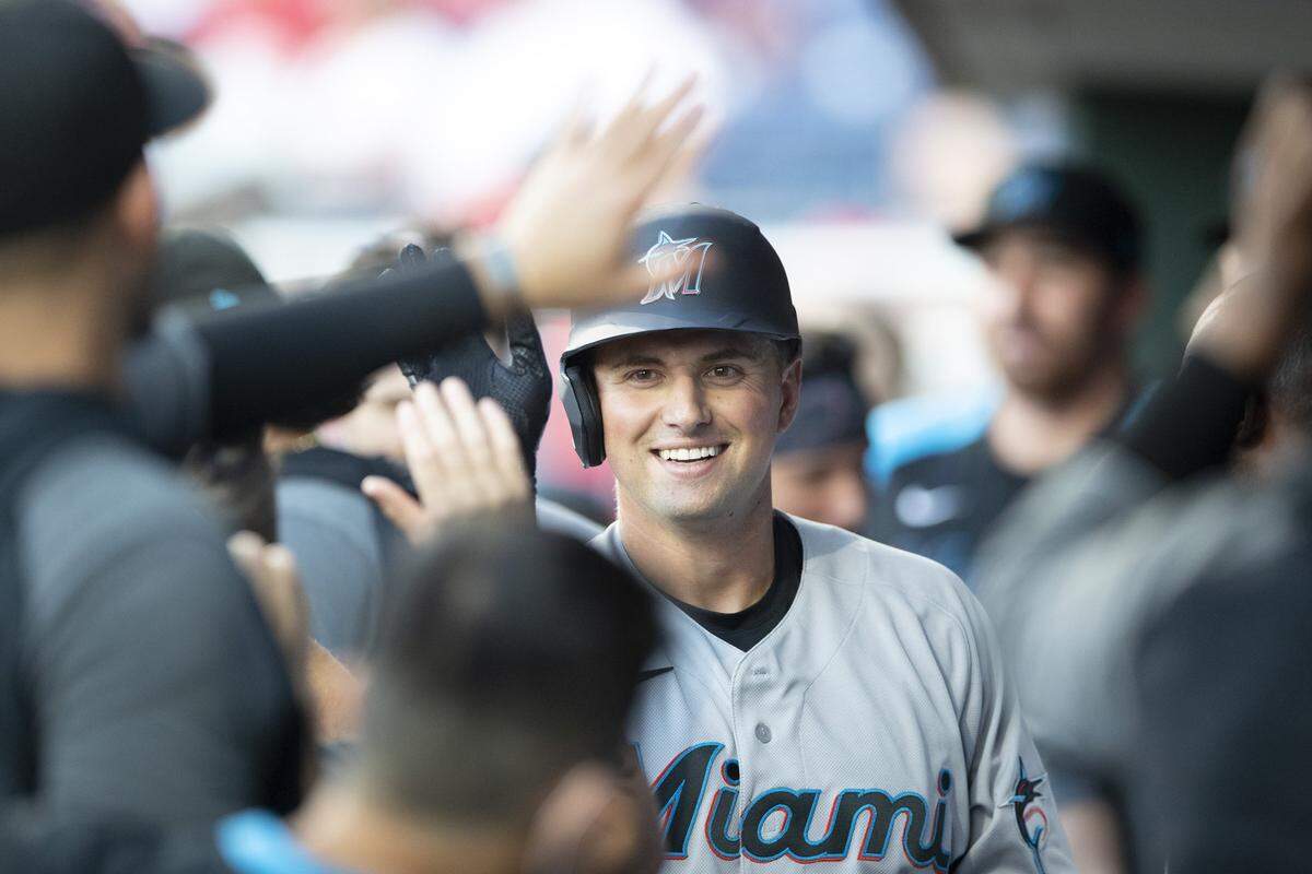Joe Panik #12 of the Miami Marlins high-fives his teammates after hitting a solo home run in the top of the second inning against the Philadelphia Phillies at Citizens Bank Park on June 30, 2021 in Philadelphia, Pennsylvania.