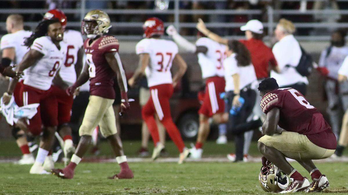 Florida State defensive tackle Dennis Briggs Jr., right, pauses on the field as Jacksonville State celebrates after an NCAA college football game Saturday, Sept. 11, 2021, in Tallahassee, Fla. Jacksonville State won 20-17.