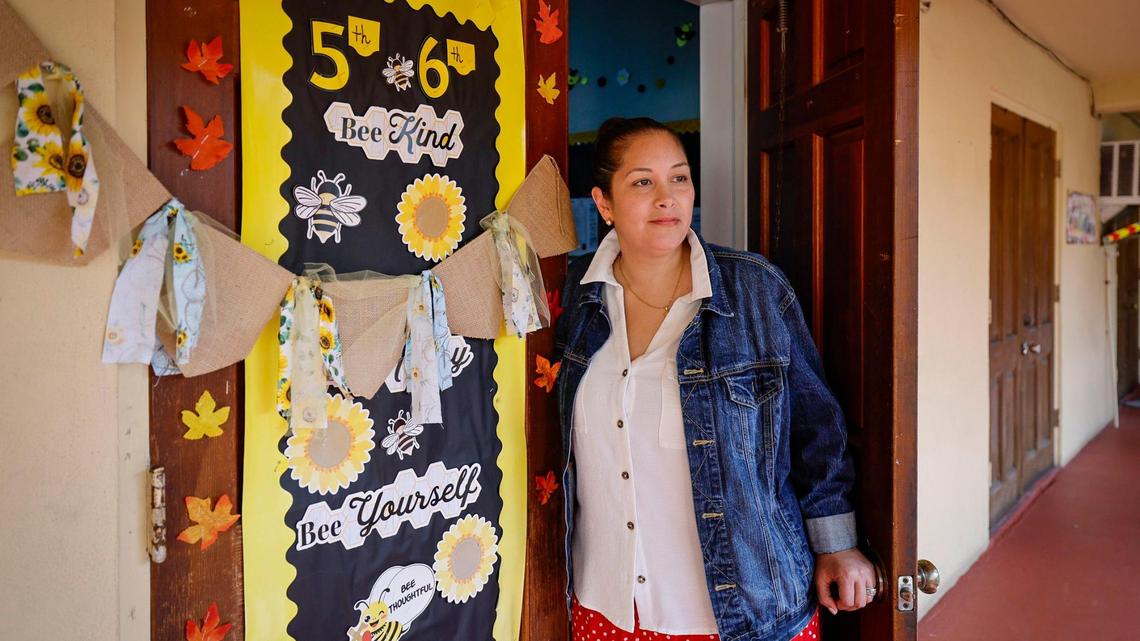Maria Vasquez stands outside her classroom at Citi Christian Academy in Miami on Friday, Nov. 1, 2024. Vasquez quit her job as a fifth- and sixth-grade teacher three years ago to take care of her newborn daughter and was only able to return to the workforce when her mother-in-law retired and could watch her daughter during the day.