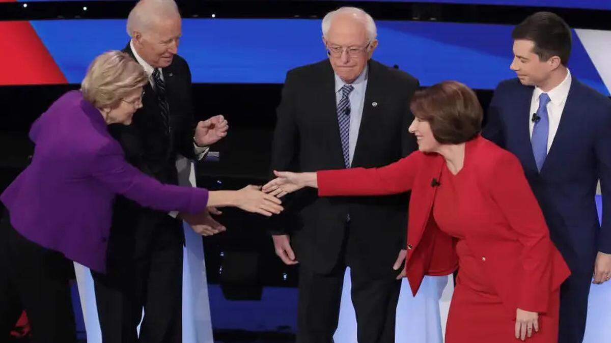 Sens. Elizabeth Warren and Amy Klobuchar greet each other ahead of the January Democratic presidential primary debate in Des Moines, Iowa.