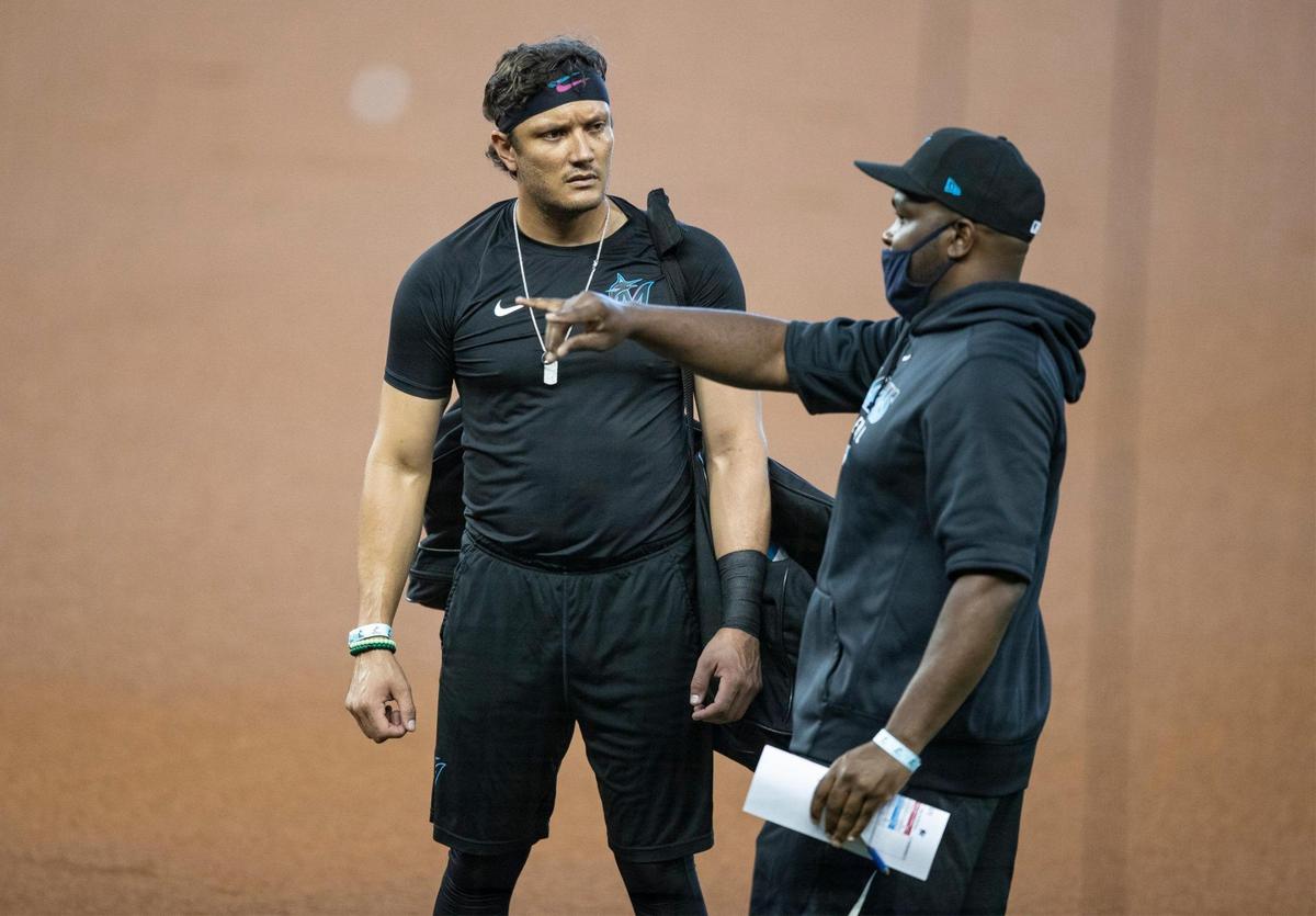 Miami Marlins bench coach James Rowson talks with shortstop Miguel Rojas on the first day of Marlins training camp at Marlins Park on Friday, July 3, 2020.
